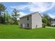 Back exterior view of the home with a bright green lawn and vinyl siding at 20 Sloane Ct, Covington, GA 30016