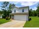 Charming two-story home with lush green lawn featuring a two-car garage and plenty of parking at 20 Sloane Ct, Covington, GA 30016
