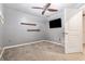 Bedroom featuring a ceiling fan, mounted shelves, and a wall-mounted TV at 2114 Gorman Se Grv, Atlanta, GA 30316