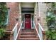 Brick steps lead to front entrance showcasing a bright red door with address numbers at 2114 Gorman Se Grv, Atlanta, GA 30316