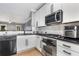 Well-equipped kitchen featuring stainless steel appliances, dark countertops, and bright white cabinetry at 2114 Gorman Se Grv, Atlanta, GA 30316