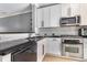 A lovely kitchen boasting stainless steel appliances, dark countertops, and beautiful white cabinetry at 2114 Gorman Se Grv, Atlanta, GA 30316