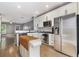 Contemporary kitchen showcasing white cabinetry, island, stainless steel appliances, and hardwood floors at 2114 Gorman Se Grv, Atlanta, GA 30316