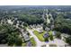 An aerial view highlights a neighborhood surrounded by trees, featuring neatly arranged houses and streets at 3269 N Winds N Trl, Douglasville, GA 30135