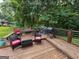 Outdoor deck with a grill, wood decking, table and chairs for entertaining at 3269 N Winds N Trl, Douglasville, GA 30135