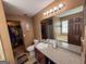 Well-lit bathroom featuring a vanity, large mirror, toilet, and walk-in closet at 3269 N Winds N Trl, Douglasville, GA 30135