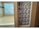 Bathroom with bathtub, tiled walls, and a shower with a patterned curtain at 3269 N Winds N Trl, Douglasville, GA 30135