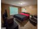Well-lit bedroom with a red and black comforter, window, and wood floors at 3269 N Winds N Trl, Douglasville, GA 30135