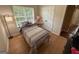 Bright bedroom with a plush teddy bear, window, and a double door closet for storage at 3269 N Winds N Trl, Douglasville, GA 30135