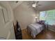 Cozy bedroom featuring a vaulted ceiling, ceiling fan, and a window providing natural light at 3269 N Winds N Trl, Douglasville, GA 30135