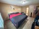 Well-lit bedroom with a black and red comforter, and hardwood floors at 3269 N Winds N Trl, Douglasville, GA 30135