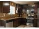Bright kitchen with stainless steel appliances, light countertops and dark wood cabinets at 3269 N Winds N Trl, Douglasville, GA 30135