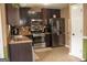 Modern kitchen featuring stainless steel appliances, dark cabinets, and granite countertops at 3269 N Winds N Trl, Douglasville, GA 30135