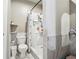 Updated bathroom featuring a toilet, shower, and modern tile at 5022 Audubon Pl, Norcross, GA 30093