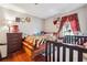 Cozy bedroom with hardwood floors, complemented by a warm color palette and natural light from the window at 5022 Audubon Pl, Norcross, GA 30093