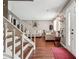 Bright living room with hardwood floors and staircase features a comfortable seating area and a welcoming ambiance at 5022 Audubon Pl, Norcross, GA 30093