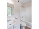Bright bathroom features a white vanity with sink and a tub-shower combo at 765 Martin Rd, Stone Mountain, GA 30088