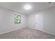 This cozy bedroom has neutral carpet, a window, and a white door at 765 Martin Rd, Stone Mountain, GA 30088