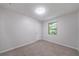 This cozy bedroom has neutral carpet, a window, and a white door at 765 Martin Rd, Stone Mountain, GA 30088