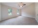 Primary bedroom with vaulted ceiling, two windows, and neutral carpeting at 765 Martin Rd, Stone Mountain, GA 30088