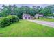 Charming two-story home with a two-car garage, stone accents, and a lush, green front yard at 765 Martin Rd, Stone Mountain, GA 30088