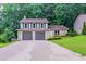 Charming two-story home featuring a two-car garage and well-manicured front lawn surrounded by lush greenery at 765 Martin Rd, Stone Mountain, GA 30088
