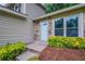 Charming home entryway features a stone facade, a decorative front door, and manicured landscaping at 765 Martin Rd, Stone Mountain, GA 30088