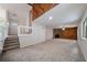 Spacious living room featuring a stone fireplace, and decorative wood-panelled wall accents at 765 Martin Rd, Stone Mountain, GA 30088