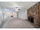 Spacious living room featuring a stone fireplace and views of stairs and dining area at 765 Martin Rd, Stone Mountain, GA 30088