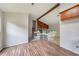 Open-concept living area with modern floors, stairs to the second level, and a decorative beam at 765 Martin Rd, Stone Mountain, GA 30088