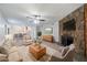 Inviting living room featuring a cozy stone fireplace, plush seating, and an open layout to the dining area at 765 Martin Rd, Stone Mountain, GA 30088