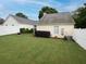 Large backyard with lush green lawn and white fence, perfect for outdoor activities and privacy at 2790 Barnwood Xing, Duluth, GA 30097