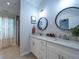 Bright bathroom with double vanity, quartz countertop, round mirrors, and walk-in shower at 2790 Barnwood Xing, Duluth, GA 30097