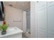 Bright bathroom featuring a vanity with quartz countertop, round mirror, and shower with white subway tile at 2790 Barnwood Xing, Duluth, GA 30097