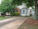 Exterior view of home showcasing the front yard landscaping and a long driveway at 2790 Barnwood Xing, Duluth, GA 30097