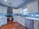 Contemporary kitchen featuring white cabinetry, stainless steel appliances, and wood flooring at 2790 Barnwood Xing, Duluth, GA 30097