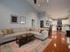 Cozy living room features a large sectional couch and seamless flow into the modern kitchen at 2790 Barnwood Xing, Duluth, GA 30097