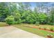 Expansive backyard featuring lush greenery and a concrete patio, perfect for outdoor relaxation at 3179 Woodward Down Trl, Buford, GA 30519