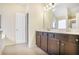 Bathroom featuring double vanity with dark wood cabinets and tile flooring at 3179 Woodward Down Trl, Buford, GA 30519