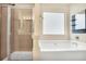 Bright bathroom with tile shower and separate soaking tub at 3179 Woodward Down Trl, Buford, GA 30519