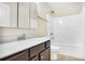 Bright bathroom features a shower-tub combo and a vanity with a large mirror at 3179 Woodward Down Trl, Buford, GA 30519
