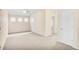 Spacious carpeted bedroom with neutral tones, ceiling fan, and natural light from three windows at 3179 Woodward Down Trl, Buford, GA 30519
