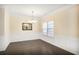 Bright dining room with dark wood floors, white wainscoting, and an elegant chandelier at 3179 Woodward Down Trl, Buford, GA 30519