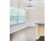 Bright dining area featuring large windows, hardwood floors, and contemporary lighting fixtures at 3179 Woodward Down Trl, Buford, GA 30519