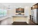 Stylish kitchen with granite island, stainless steel appliances, and hardwood floors flowing into the dining area at 3179 Woodward Down Trl, Buford, GA 30519