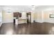 Open-concept kitchen and living area with hardwood floors, stainless steel appliances, and natural light at 3179 Woodward Down Trl, Buford, GA 30519