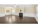 Spacious living room with fireplace and wainscoting offers dark wood floors and great natural light at 3179 Woodward Down Trl, Buford, GA 30519