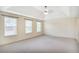 Large primary bedroom featuring a trey ceiling, neutral carpet and lots of natural light at 3179 Woodward Down Trl, Buford, GA 30519