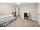 A simply furnished bedroom with neutral colors and a dedicated desk area at 3962 Fairington Dr, Marietta, GA 30066