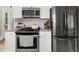 Modern kitchen features granite countertops, stainless steel appliances, and white cabinets at 3962 Fairington Dr, Marietta, GA 30066
